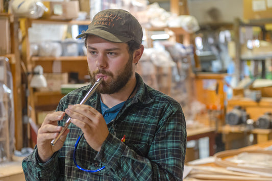 Traditional tin penny whistle player