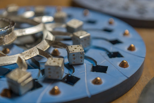 Reproduction lead-free pewter dice in the casting mold